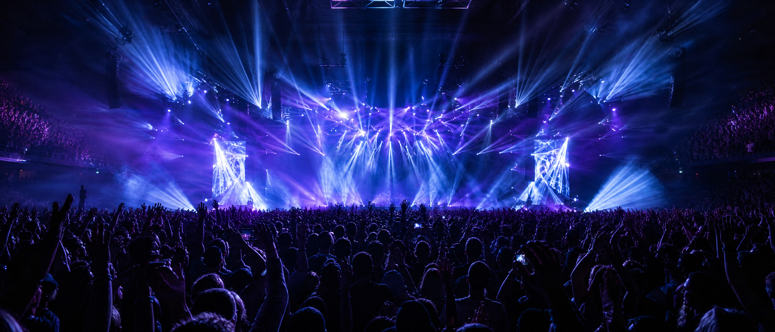 Concert crowd with dramatic stage lighting
